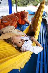 A woman relaxes in a hammock in Brazil. - AURF00428