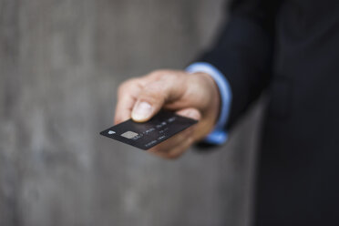 Close-up of businessman holding credit card - DIGF04844