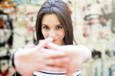 Portrait of young woman stretching her arms - GIOF04142