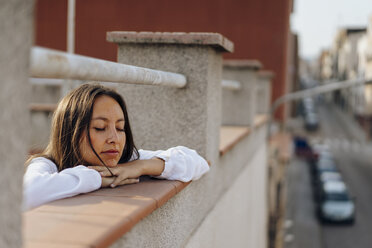 Porträt einer jungen Frau, die sich auf einer Dachterrasse entspannt - AFVF01405