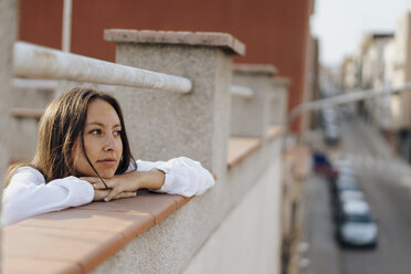 Portrait of young woman relaxing on roof terrace - AFVF01406