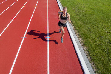 Female track and field athletes running on sunny track Stock Photo - Alamy