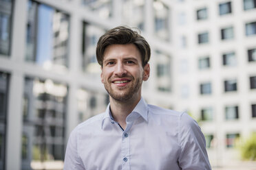 Portrait of smiling businessman in the city - DIGF04913