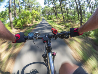 France, Landes, senior man on e-bike in the forest - LAF02074