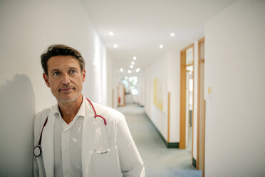 Doctor standing in hospital with stethoscope around neck, portrait - GUSF01078