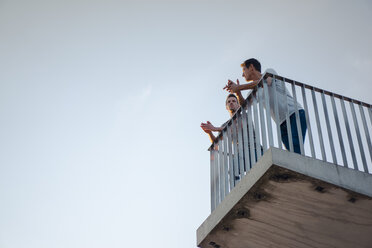 Two friends standing on observation platform, talking - GUSF01202