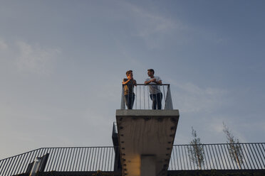 Two friends standing on observation platform, talking - GUSF01211