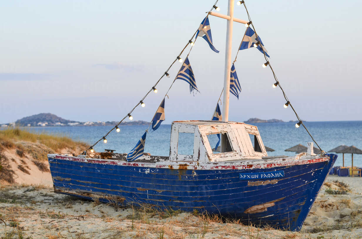 Traditional old blue fishing boat on a beach, island of Naxos