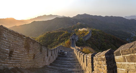 View down steps of the Great Wall, Mutianyu, Beijing, China, with mountain landscape in the distance. - MINF08884