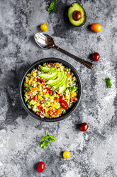 Bowl of bulgur salad with bell pepper, tomatoes, avocado, spring onion and parsley - SARF03918