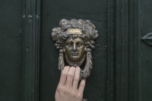 Woman's hand on door knocker, close-up - CHPF00506