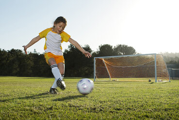 A young girl playing soccer on a soccer field in Los Angeles, California. - AURF00580