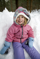 Girl playing in snow on winter day. - AURF00660