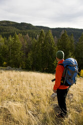 A young man enjoys the view while backpacking in Grand Teton National Park, Wyoming. - AURF00673