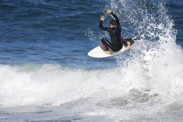 A young man surfing at Rebounds, on the South Arm Peninsular, in Tasmania. - AURF00683