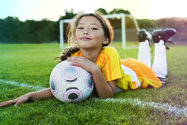 A young girl posing with her soccer ball on a soccer field in Los Angeles, California. - AURF00750