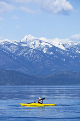 An adventurous retired man kayaking across a huge calm lake in Idaho. - AURF00842