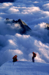 Zwei Menschen über den Wolken auf dem Gipfel eines Hügels, Neuseeland. - AURF00910