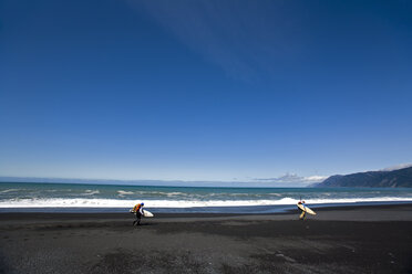 Two men hike with surfboards on The Lost Coast, California. - AURF00933