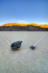 Two rocks leave trails of their movement on The Racetrack in Death Valley National Park at sunrise, California. - AURF00977