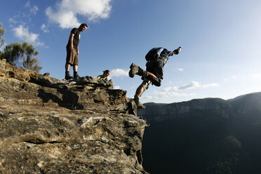 A BASE jumper performs a front flip off a cliff in the Blue Mountains, New South Wales, Australia. - AURF00989