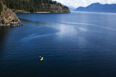 A athletic woman kayaking on a lake in Idaho. - AURF01029