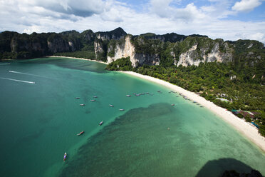 Eine Luftaufnahme von zwei großen weißen Sandstränden, umgeben von Kalksteinfelsen und türkisfarbenem Wasser mit Longtailbooten in Thailand. - AURF01042