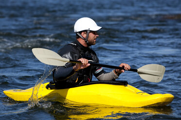 A male kayaker in a playboat paddles on the Clark Fork River, Missoula, Montana. - AURF01114