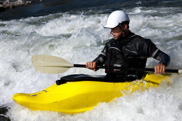 A male kayaker in a playboat paddles on the Clark Fork River, Missoula, Montana. - AURF01115