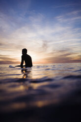 A lone surfer in the sunset. - AURF01127