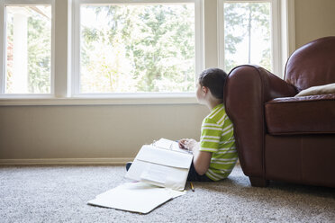 Young boy at home doing homework. - MINF08971