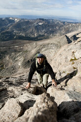 A man hikes a rocky peak in Colorado. - AURF01136