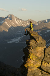 A man sitting on a slender spire along Trail Ridge Road, Rocky Mountain National Park, Estes Park, Colorado. - AURF01175