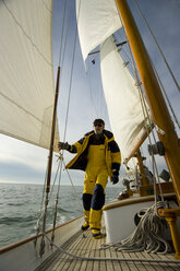 A man walks on the deck of his yacht. - AURF01179