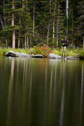 Ein älterer Mann fischt an einem bedeckten Tag im Hinterland mit der Fliege und fängt an einem See in Colorado Greenback Cutthroats. - AURF01203