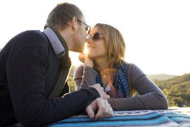 Couple approach each other to kiss on the side of the road. - AURF01304