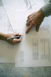 Hands pointing on a work drawing for a new kitchen - AURF01325