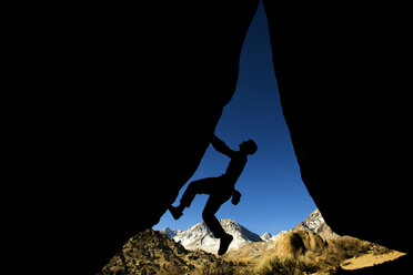 Man climbing overhang silhouette - AURF01366