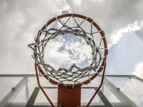 Basketballkorb gegen bewölkten Himmel, lizenzfreies Stockfoto