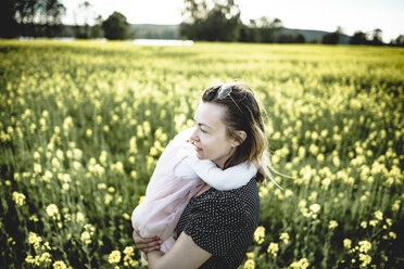 Little girl on her mother's arms in rape field - PSIF00009