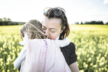 Little girl on her mother's arms in rape field - PSIF00010