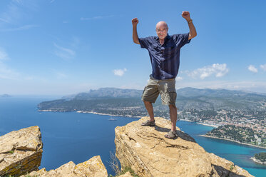 Senior man standing on cliff - FRF00717