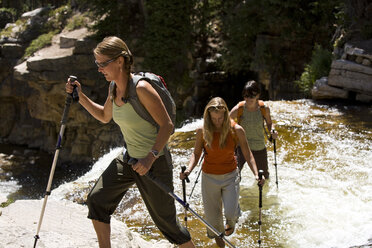 Three women wade across Utah's Provo River. - AURF01413