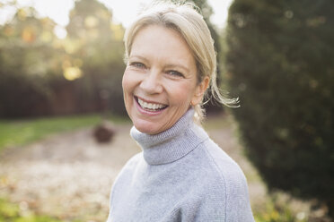 Portrait smiling, confident mature woman in backyard - HOXF03678