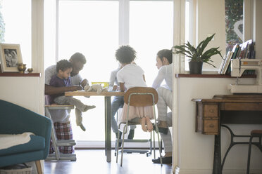 Family coloring at dining table - HOXF03755