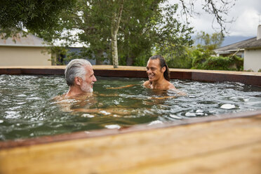 Father and son relaxing in hot tub - CAIF21362