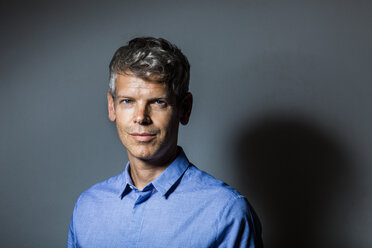 Portrait of mature man with grey hair wearing blue shirt - TCF05659