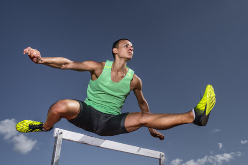 Young runner crossing hurdle - STSF01719