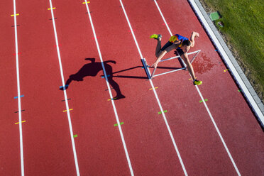 Young runner crossing hurdle - STSF01726