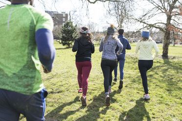 Runners running in sunny park - CAIF21596